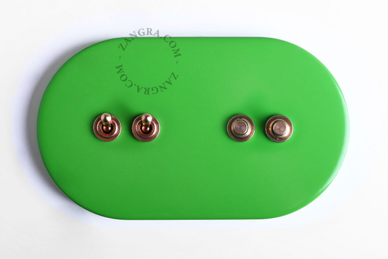 Large light switch with 2 brass pushbuttons and 2 brass toggles.