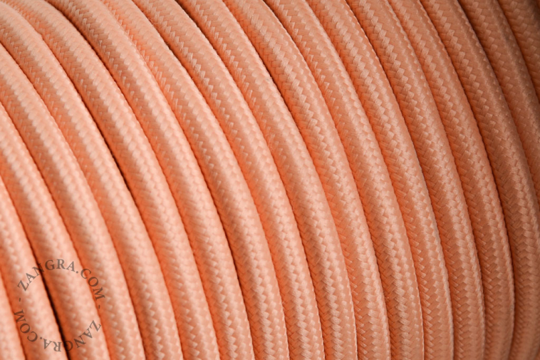 Salmon-coloured fabric cable.
