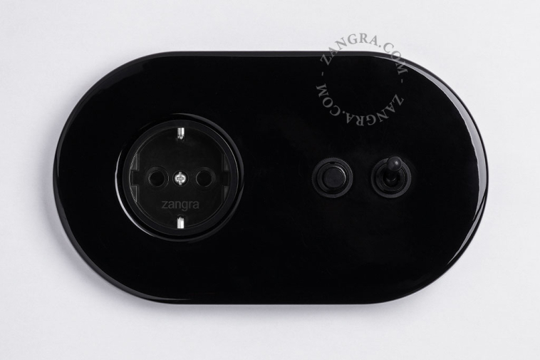 Black flush mount outlet & switch with black toggle & pushbutton.