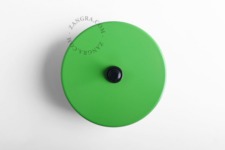 Round green and black pushbutton.