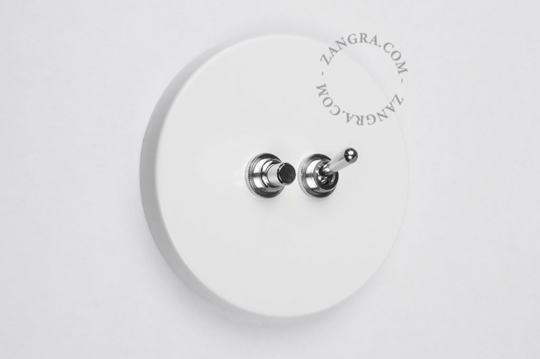 Round white light switch with two-way toggle and pushbutton
