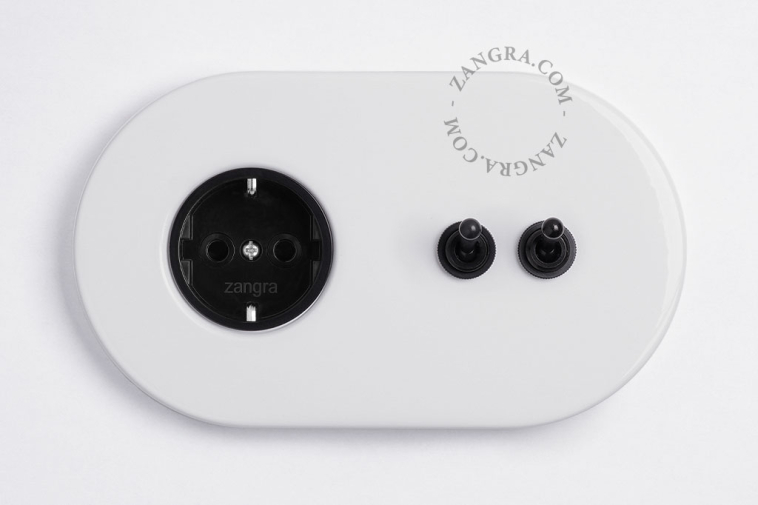 White flush mount outlet & switch with double black toggle.