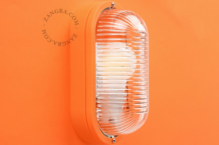 Oval orange bulkhead light.