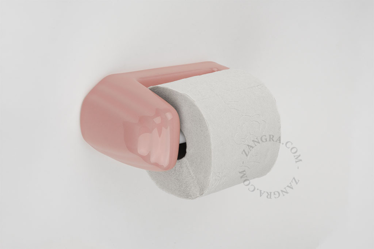 Pink porcelain toilet paper holder.