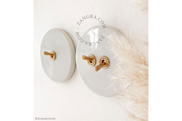 Round white porcelain light switch.