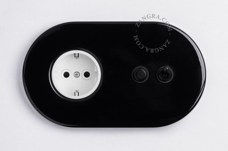 Black flush mount outlet & switch with black toggle & pushbutton.