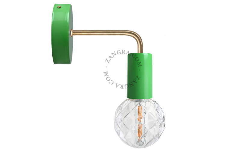 green wall light with brass arm