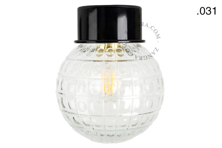 Black ceiling light with glass shade.