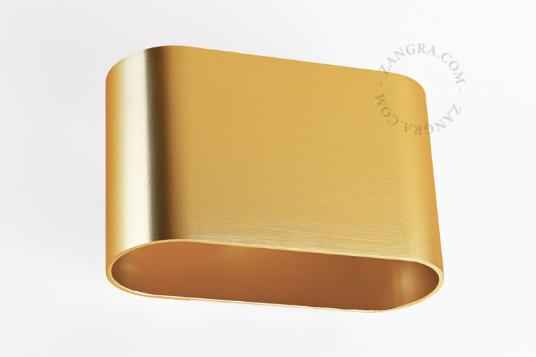 Applique bidirectionnelle dorée.