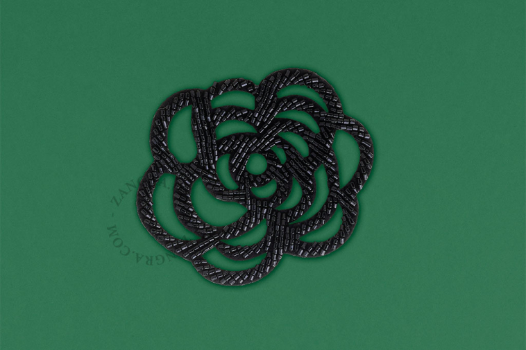 Black flower brooch.