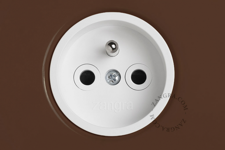 Brown flush mount outlet with switch.