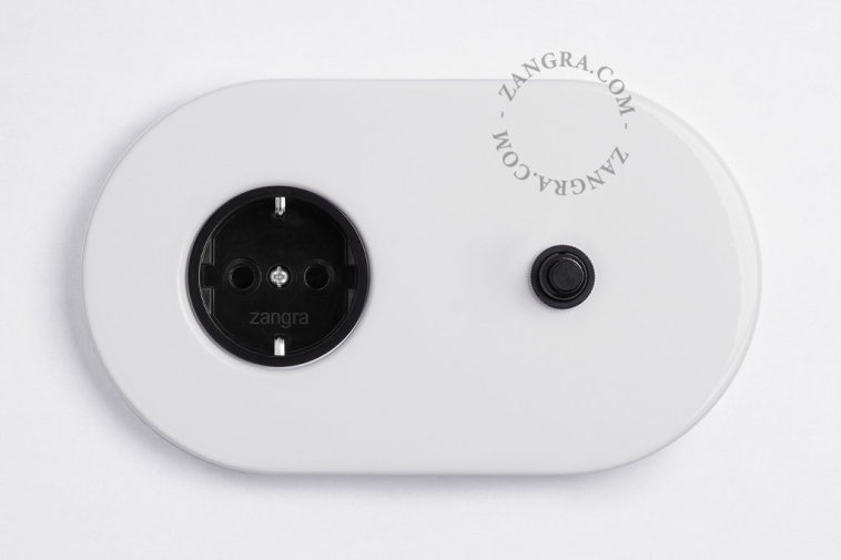 White flush mount outlet & switch with a black pushbutton.