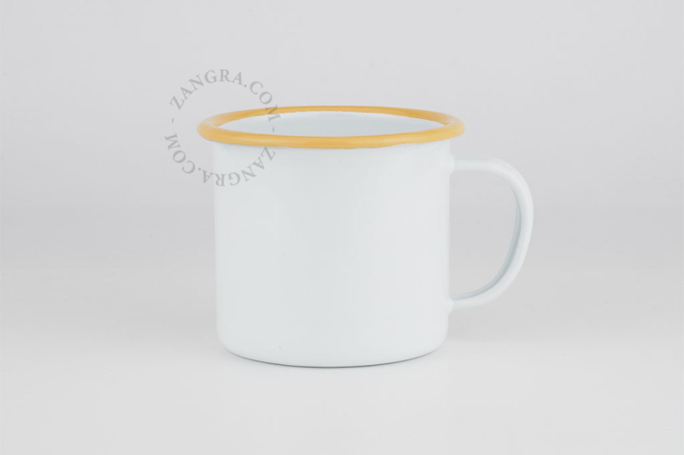 White enamel mug with yellow rim.
