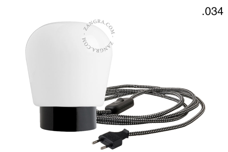 Black porcelain table lamp with glass shade.