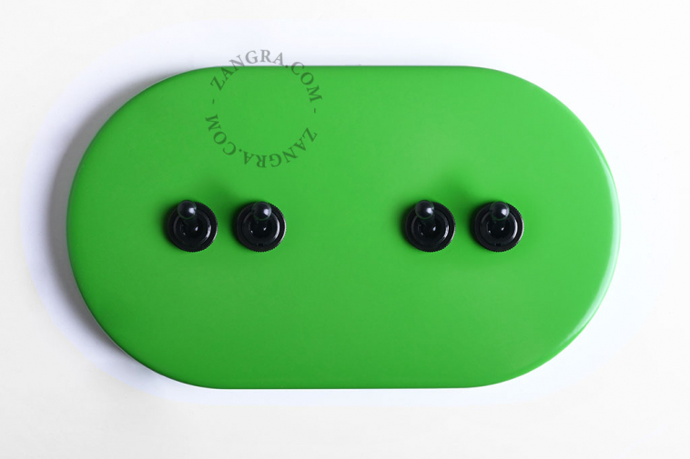 Large green ovale light switch with 4 black levers.