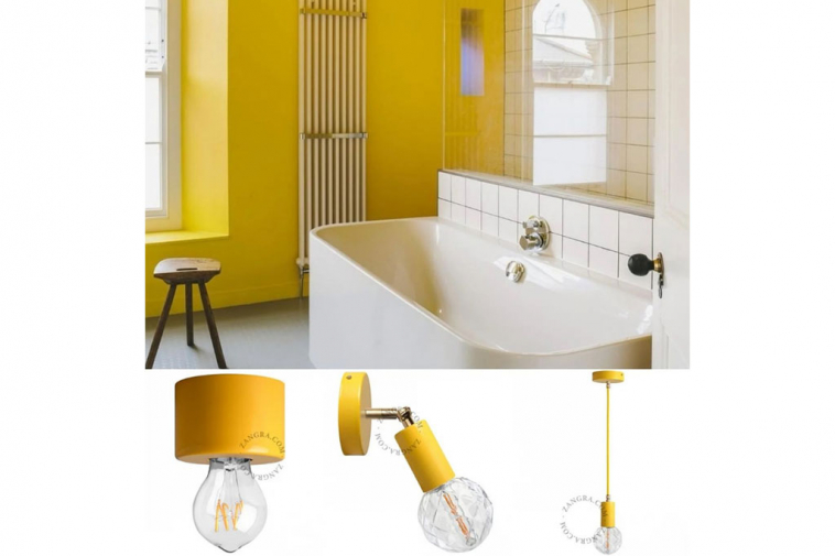 yellow adjustable wall light with brass arm
