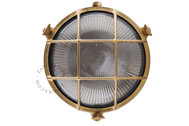 Raw brass ship light for bathroom or outdoor use.