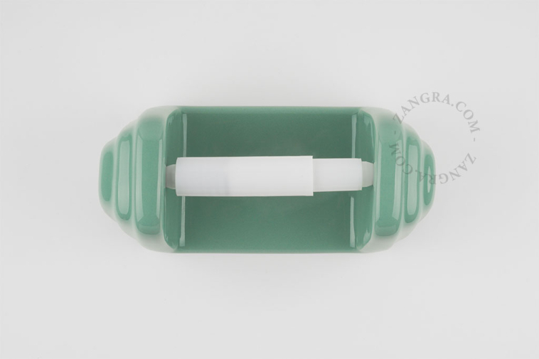 Green porcelain toilet paper holder.