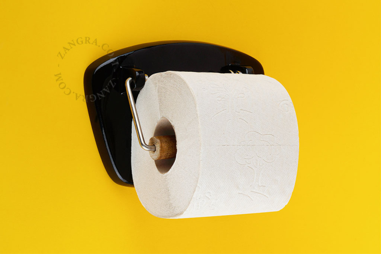 Dérouleur de papier toilette noir.