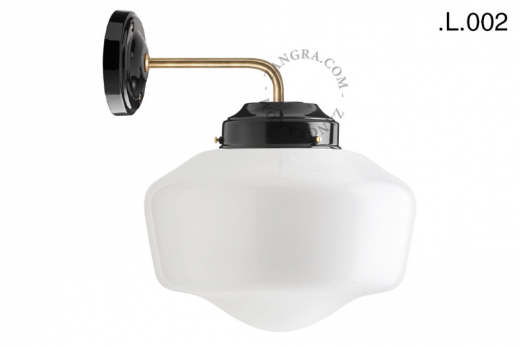 Black and brass retro wall light schoolhouse style with glass shade.
