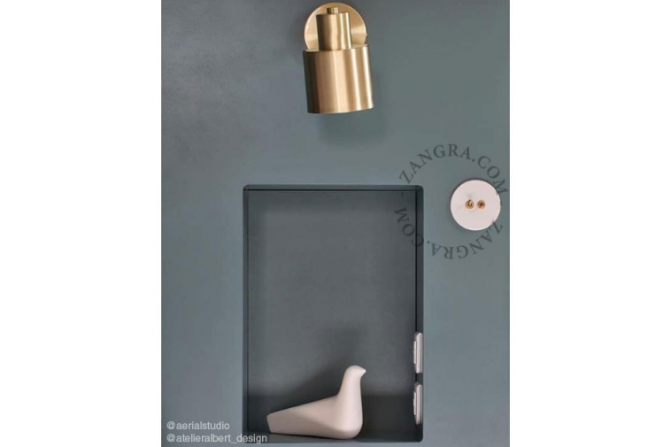 White porcelain switch with brass toggle & pushbutton.