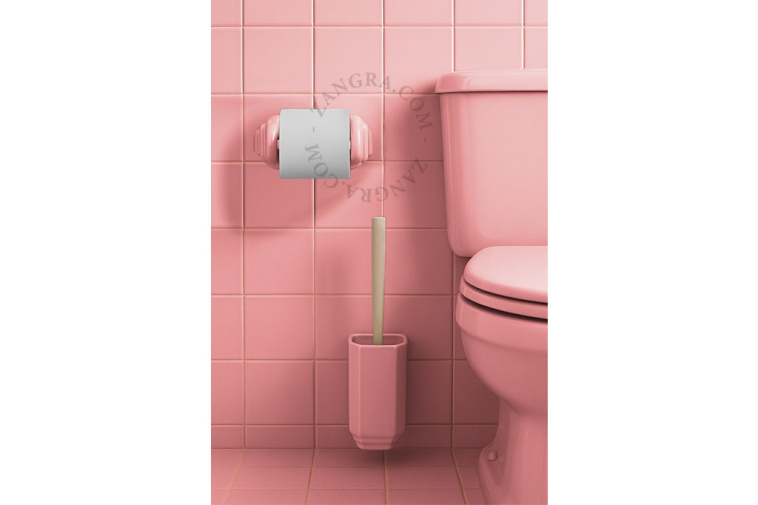 Toalettborsthållare i rosa porslin.