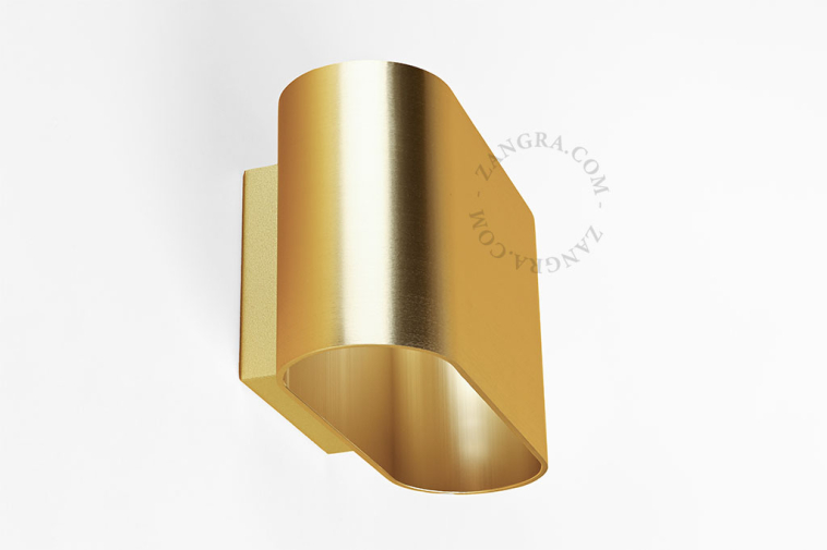 Applique bidirectionnelle dorée.