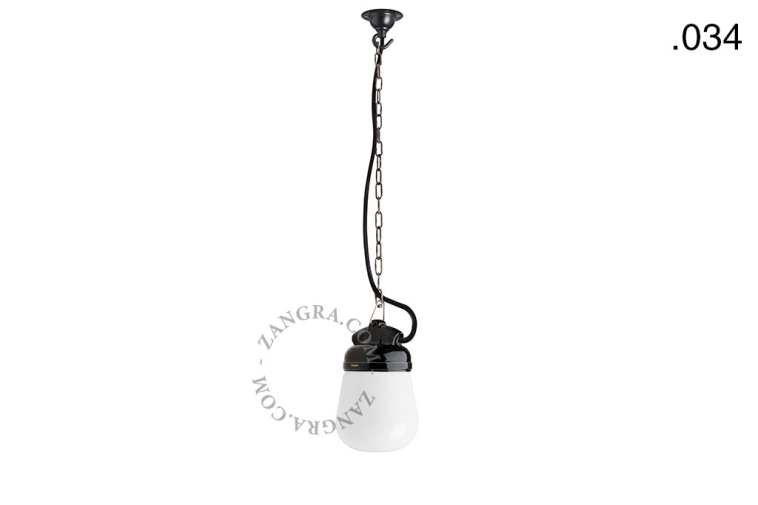 Black porcelain pendant light for outdoor use with glass globe.