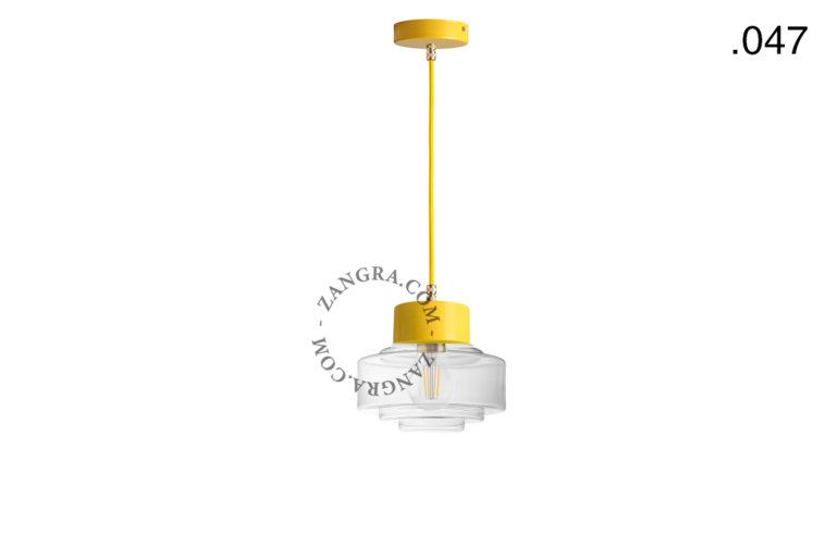 Yellow pendant light with glass shade.