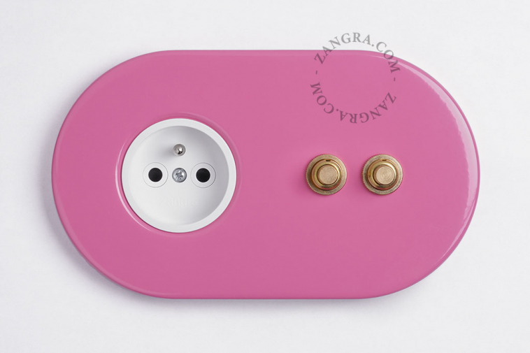 2 gold push buttons on pink integrated outlet