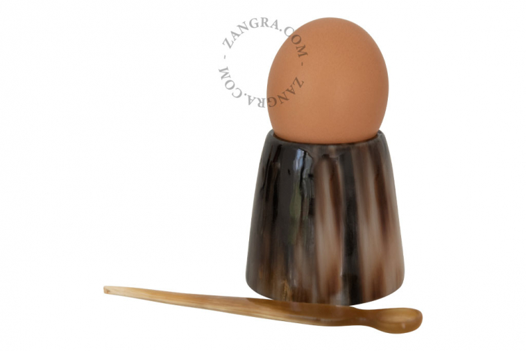 small multi-purpose horn egg cup containing a small  horn spoon