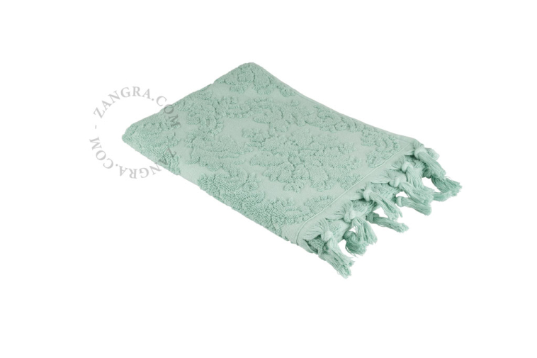 Mint green fringe towel.