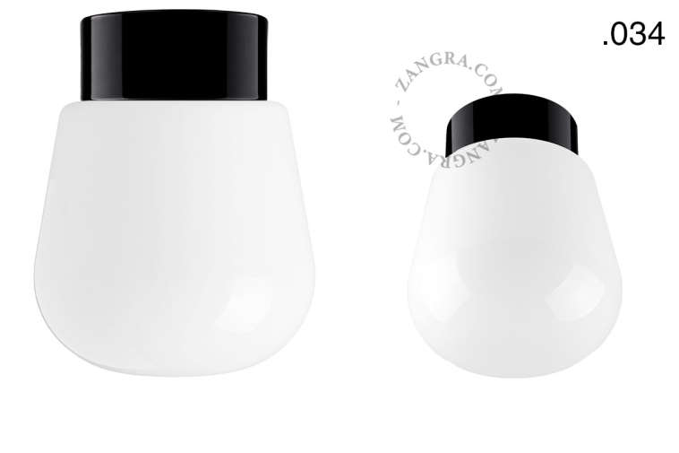 Zwarte porseleinen lamp met glazen schroefkap.