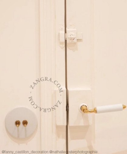 Round white porcelain light switch.