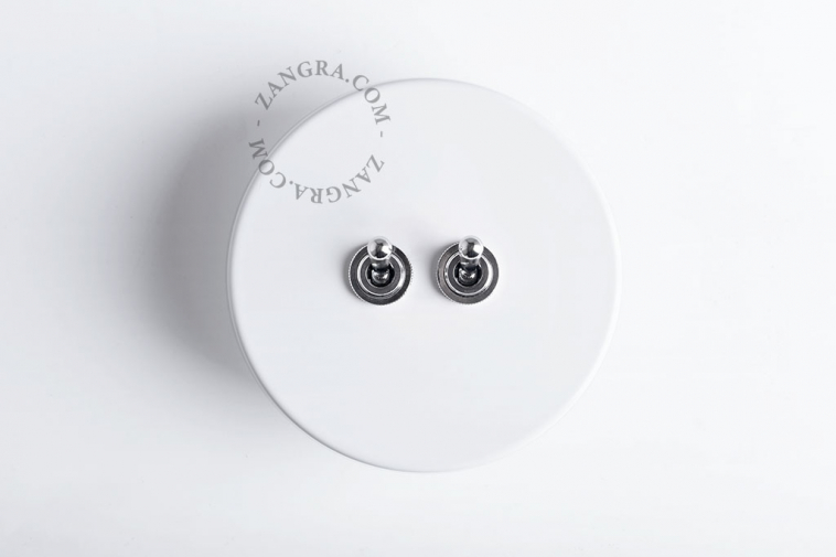 White round light switch with 2 nickel toggles