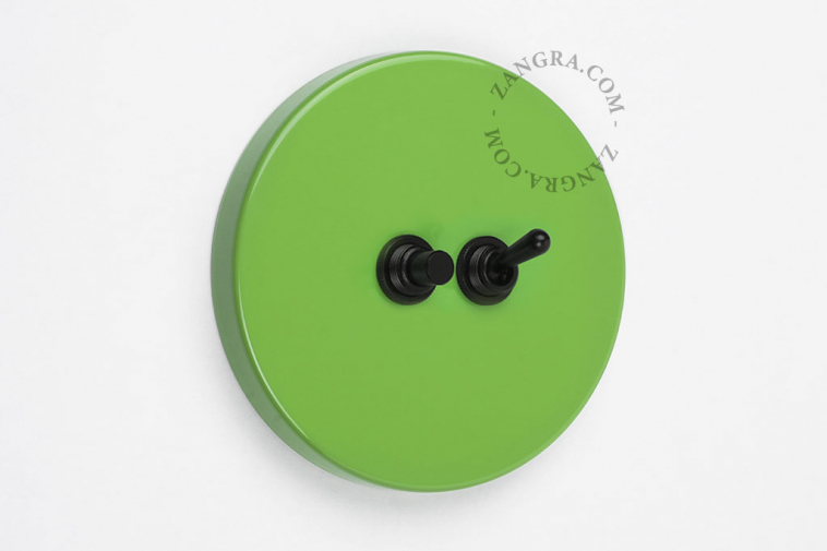 Round green light switch and pushbutton.