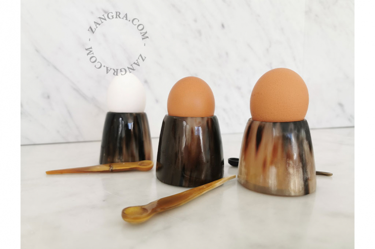 small multi-purpose horn egg cup containing a small  horn spoon