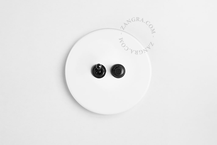 Round white porcelain light switch.