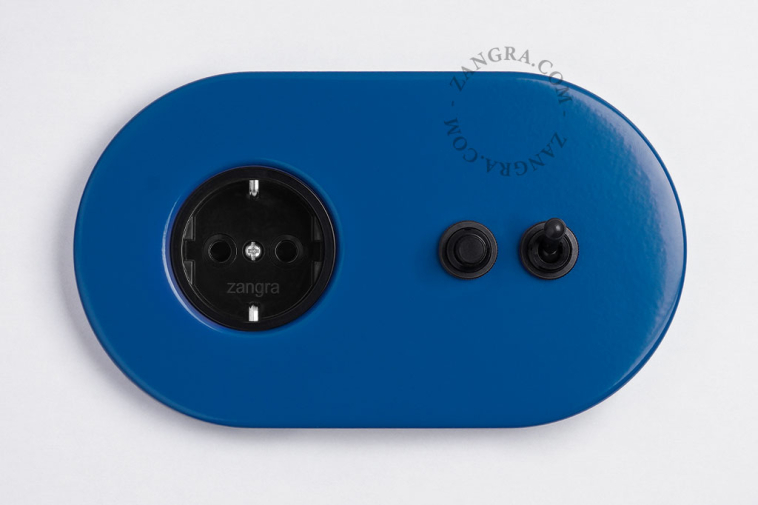 Blue flush mount outlet & switch with black toggle & pushbutton.