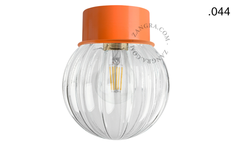 Orange ceiling light with glass shade.