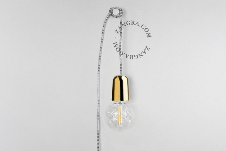 Golden porcelain plug-in pendant light with textile cable, switch and plug.