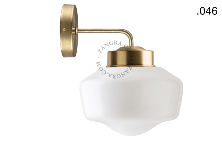 Retro brass wall light with glass shade.