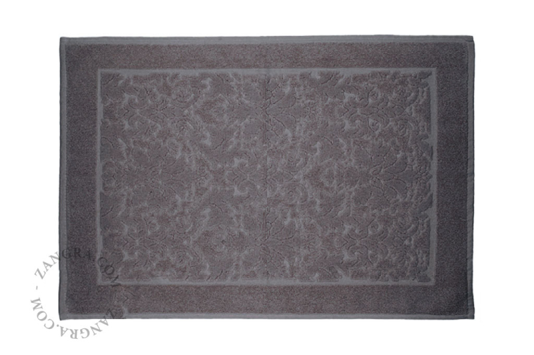 Light brown cotton bathroom mat.