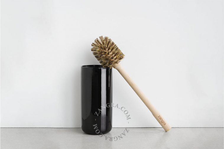 Black porcelain toilet brush holder with wooden brush.