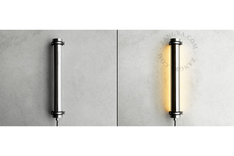 Tubular lamp made of glass and stainless steel.