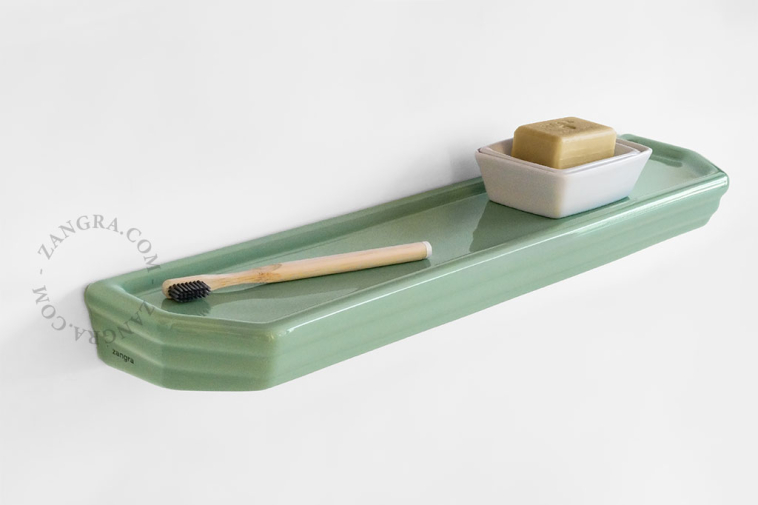 Washbasin shelf in green porcelain.