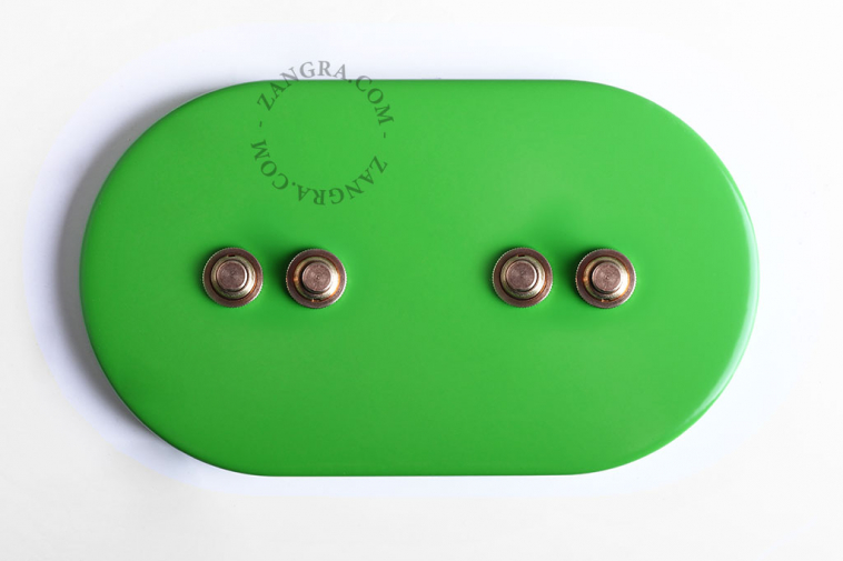 Ovale green light switch with 4 brass pushbuttons.
