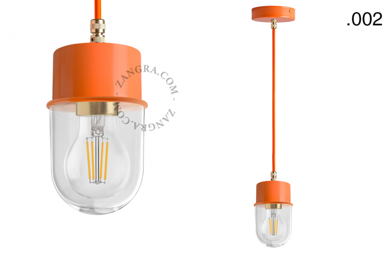 Orange pendant light with glass shade.