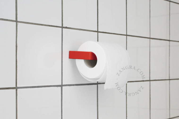 Red metal toilet paper holder.