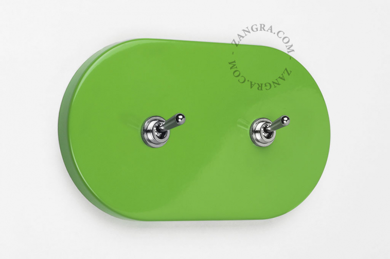 Oval green double light switch.